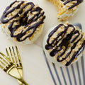 Cheesecake Crumble Donuts next to forks & a spatula