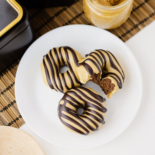 3 Chocolate PB Donuts, 1 has a bite taken out of it